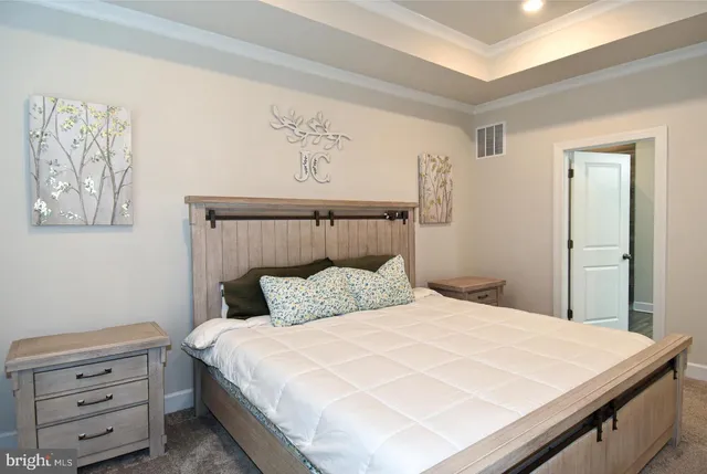 a large bed sitting in a bedroom next to a window