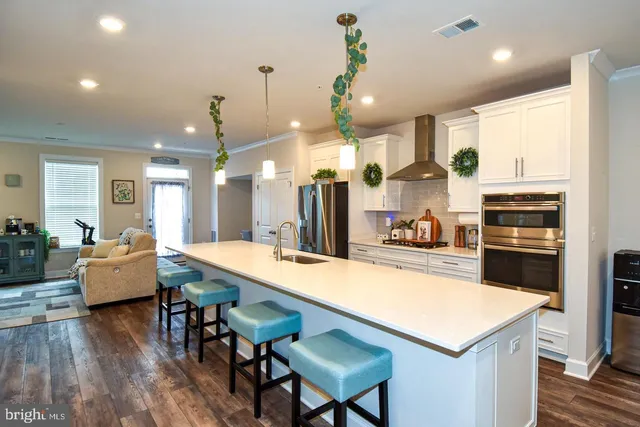 a large kitchen with stainless steel appliances lots of counter space and a refrigerator