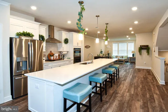 a kitchen with kitchen island a counter top space stainless steel appliances and cabinets