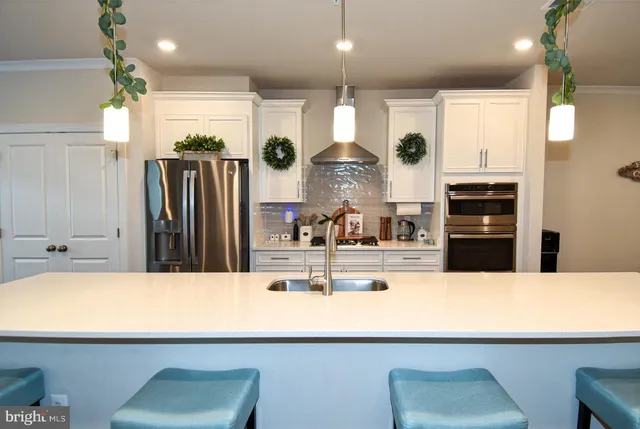 a kitchen with stainless steel appliances a refrigerator sink and cabinets