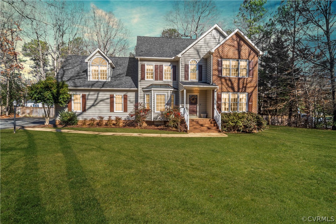 a front view of house with yard and green space