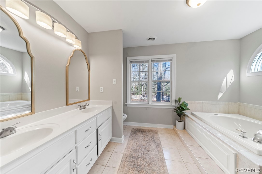 13020 Carters Way Road Chesterfield, VA 23838 - Photo 26 of 49 a spacious bathroom with a tub sink and mirror