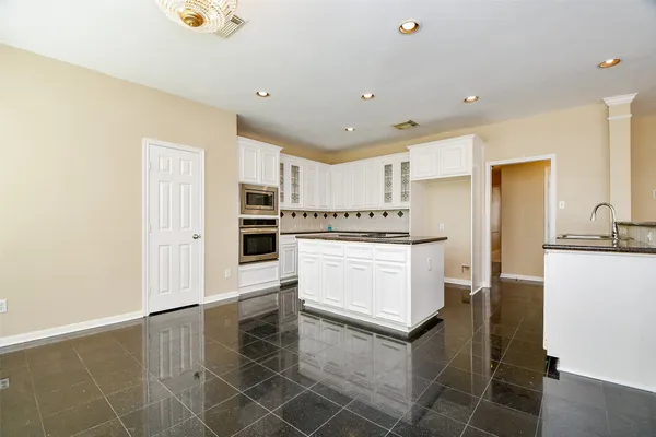 an empty room with wooden floor and a window