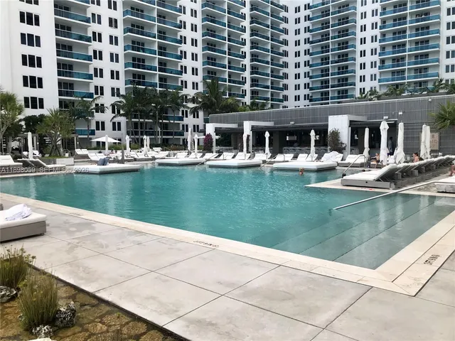 a view of a swimming pool with a lounge chairs