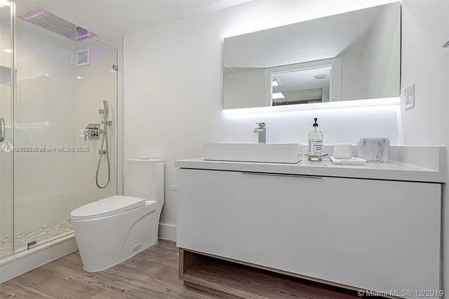a bathroom with a sink toilet and shower