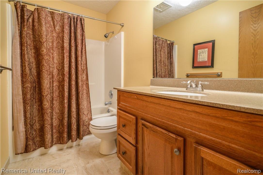 12264 Raelyn Hills Drive Perry, MI 48872 - Photo 30 of 46 Full Bath w/ Corian Counter Top and Ceramic Tile