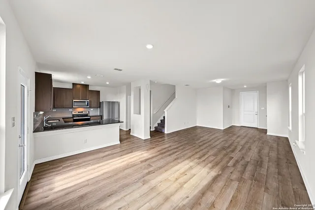 a large kitchen with a center island and stainless steel appliances