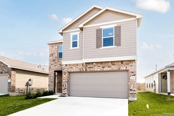 a view of a house with a yard and garage