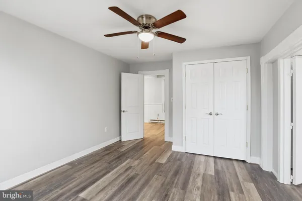 a view of an empty room and wooden floor