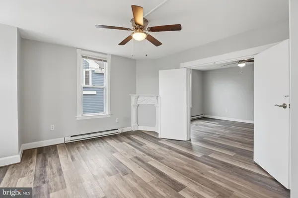 wooden floor in an empty room with a window