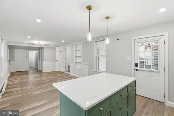 a view of a kitchen and a window in the kitchen