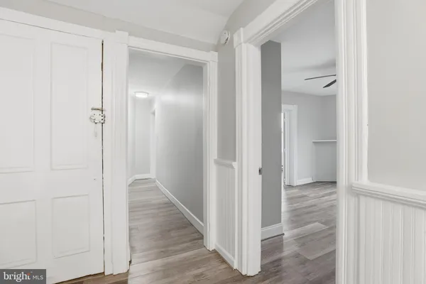 a view of a hallway with wooden floor