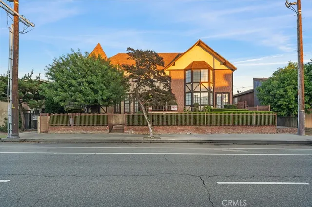 a view of swimming pool with a yard and large tree