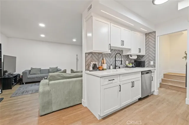 a kitchen with stainless steel appliances granite countertop a sink and cabinets