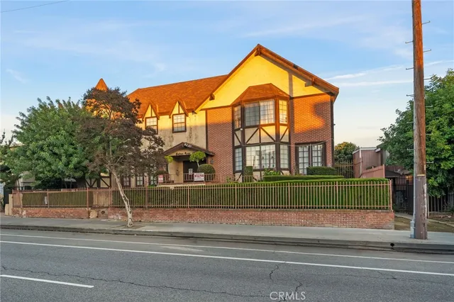 a view of a brick building next to a yard