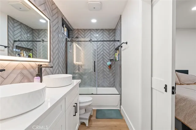 a bathroom with a sink toilet and shower