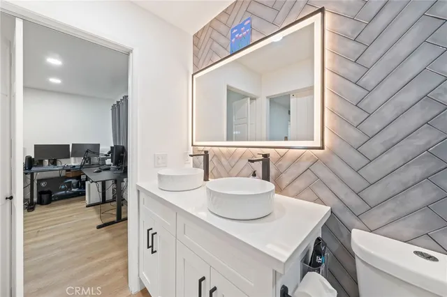 a bathroom with a sink double vanity and a mirror