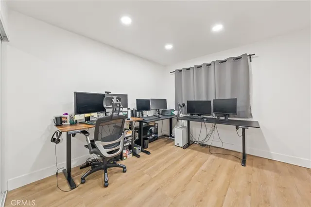 a view of a workspace with furniture and a window