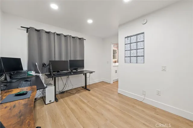 a view of a workspace with furniture and a window