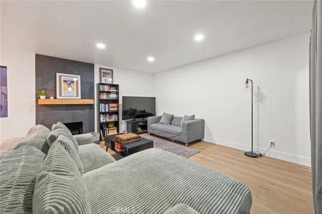 a living room with furniture a fireplace and a flat screen tv