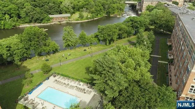 an aerial view of residential house with outdoor space and lake view