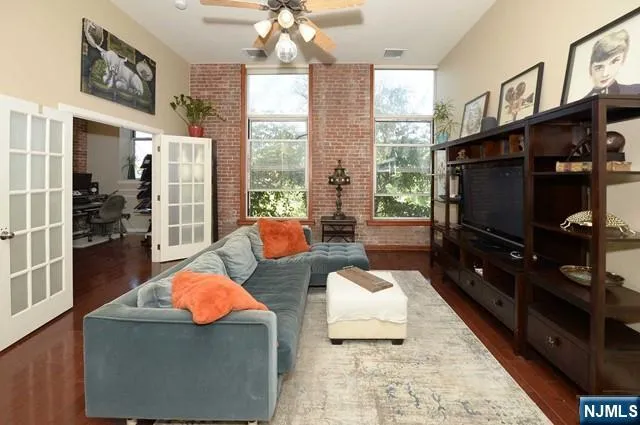 a living room with patio furniture and a flat screen tv