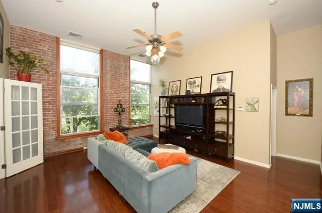 a living room with furniture a fireplace and a chandelier