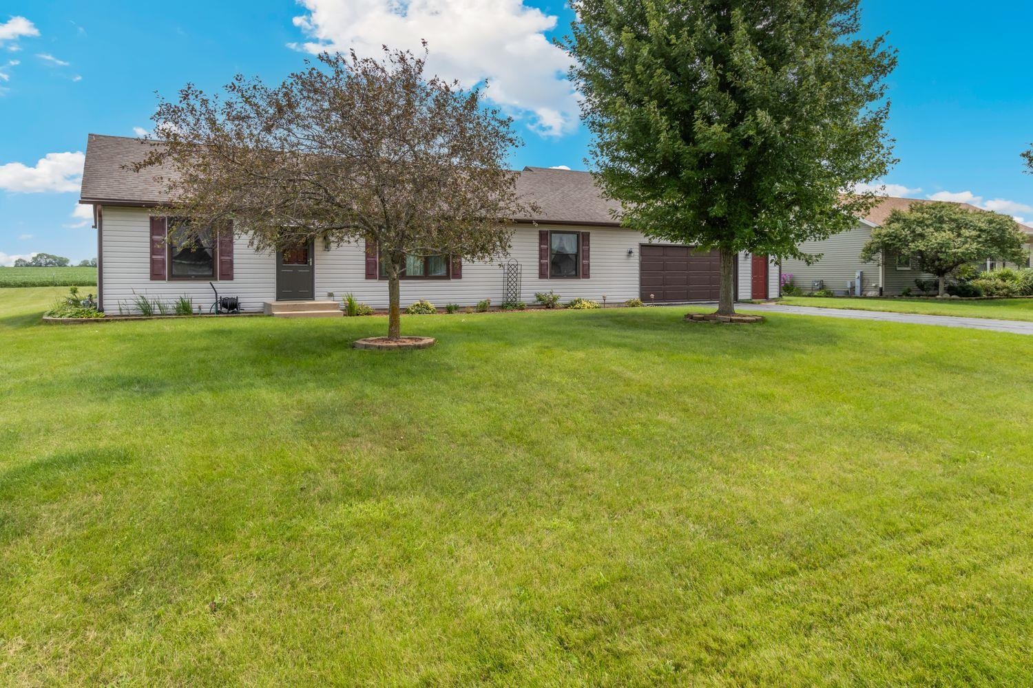 6771 Friday Road Byron, IL 61010 - Photo 1 of 25 a front view of a house with a garden