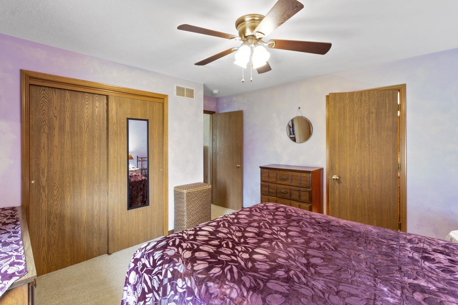 6771 Friday Road Byron, IL 61010 - Photo 11 of 25 a bedroom with a bed and a chandelier