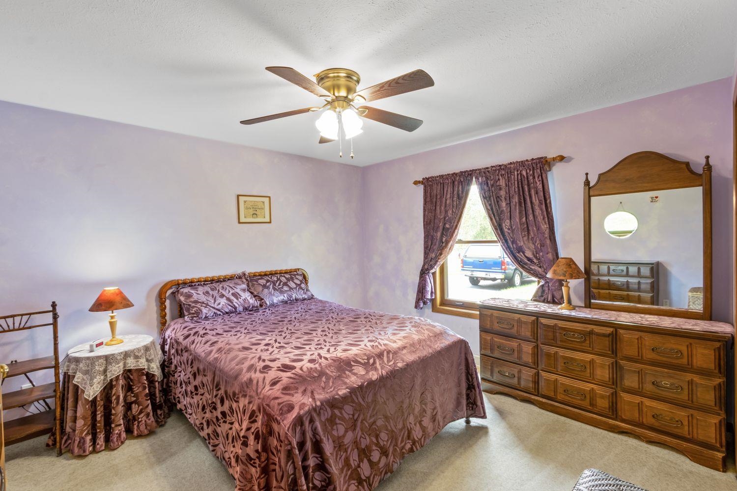 6771 Friday Road Byron, IL 61010 - Photo 12 of 25 a bedroom with a bed and a chandelier
