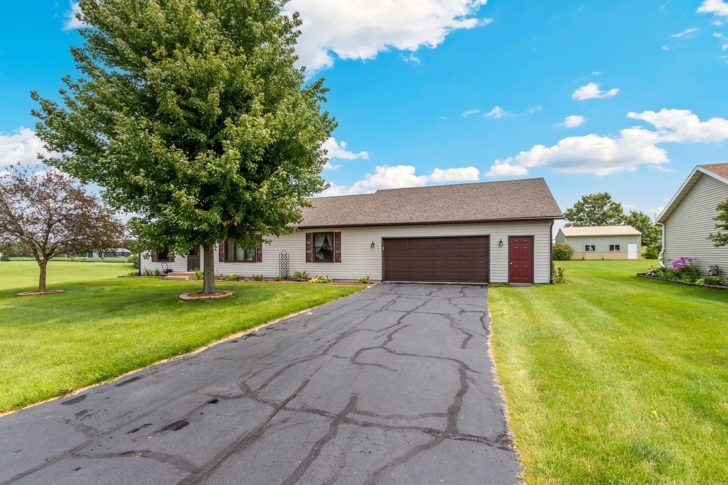 6771 Friday Road Byron, IL 61010 - Photo 2 of 25 a front view of a house with garden