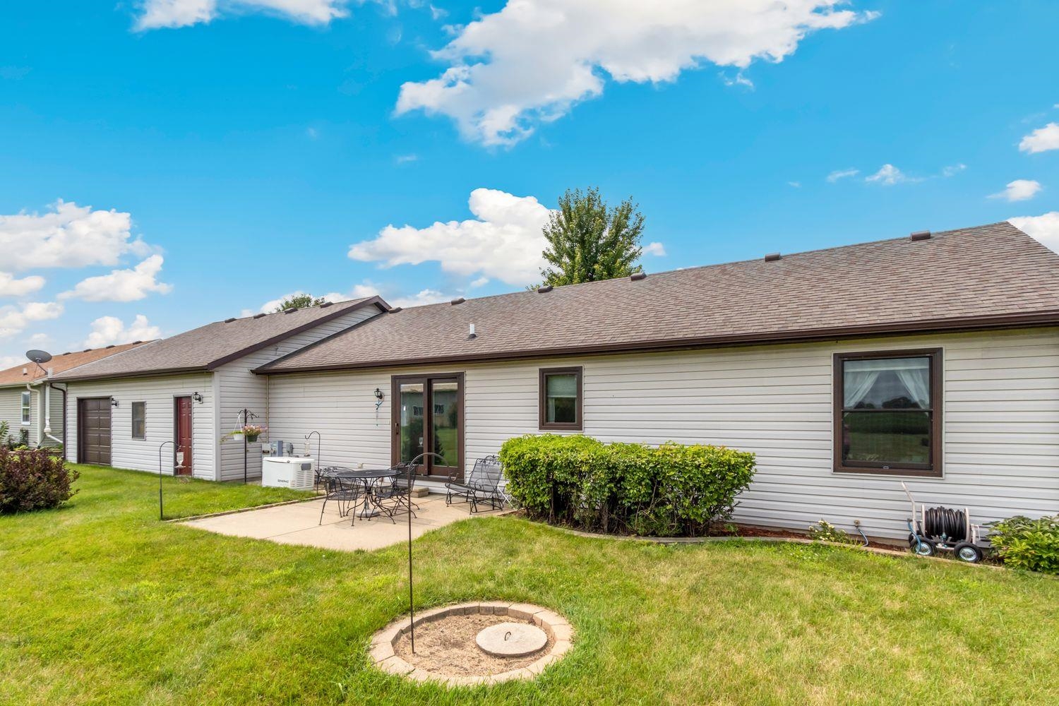 6771 Friday Road Byron, IL 61010 - Photo 3 of 25 a front view of house with yard and outdoor seating
