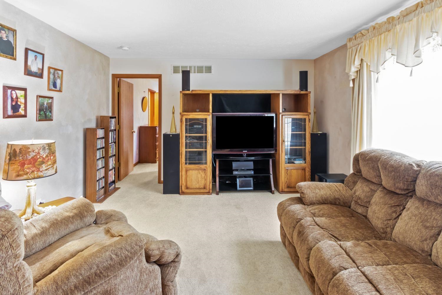 6771 Friday Road Byron, IL 61010 - Photo 5 of 25 a living room with furniture and a flat screen tv