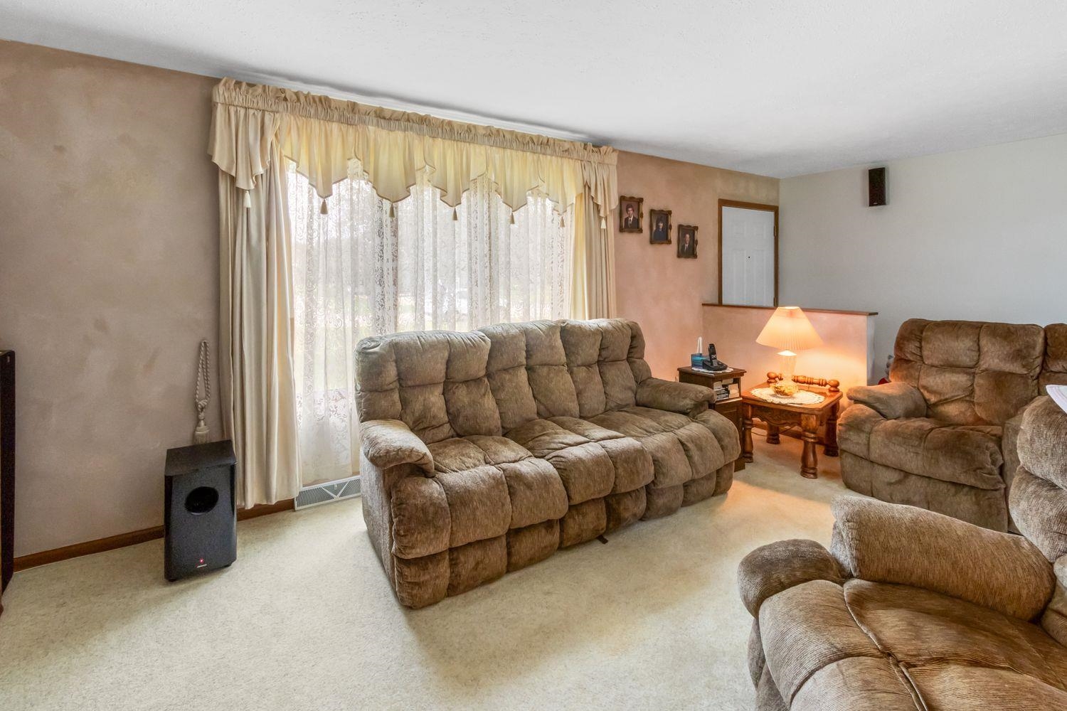 6771 Friday Road Byron, IL 61010 - Photo 6 of 25 a living room with furniture and a large window