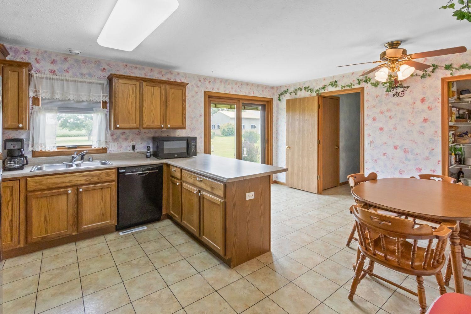 6771 Friday Road Byron, IL 61010 - Photo 9 of 25 a kitchen with a sink stove and cabinets
