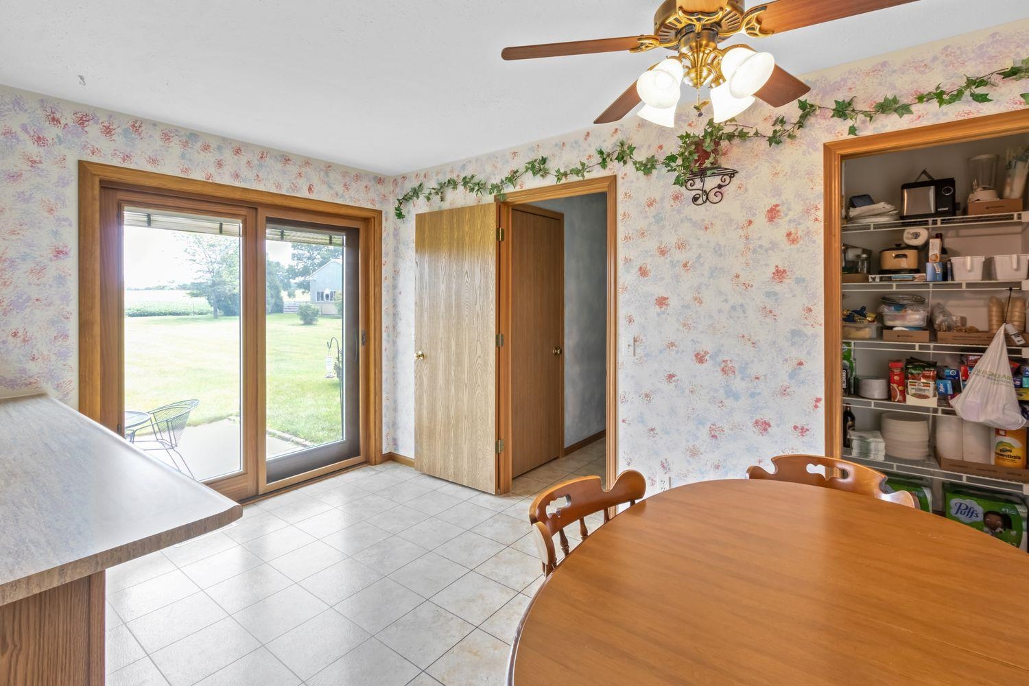 6771 Friday Road Byron, IL 61010 - Photo 10 of 25 a spacious bedroom with a bed and a chandelier
