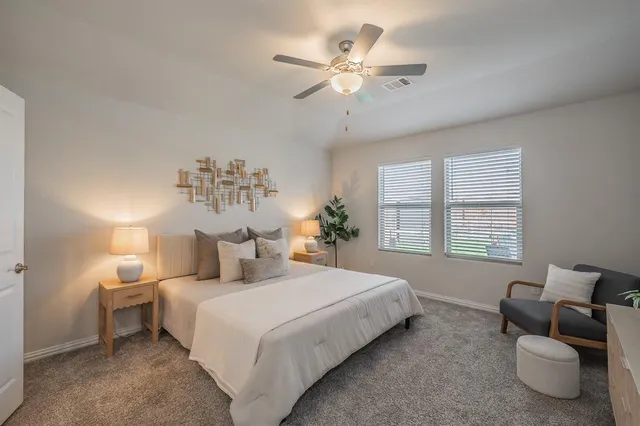 a bedroom with bed and window