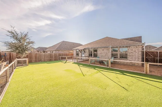 a view of a swimming pool with table and chairs under an umbrella