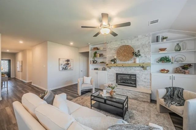 a living room with furniture and a fireplace