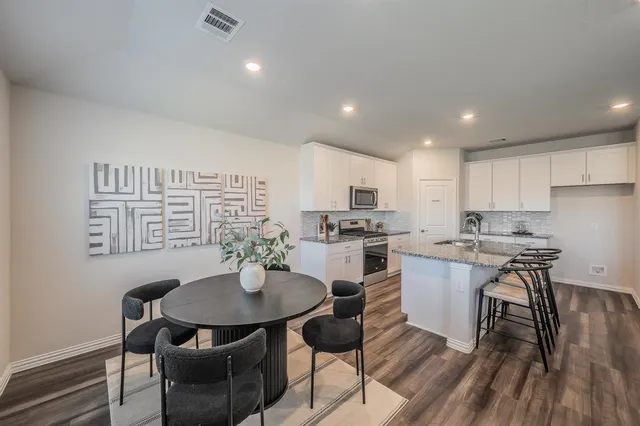 a kitchen with a table and chairs in it