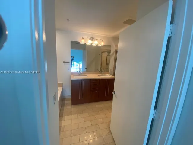 a bathroom with a double vanity sink and mirror
