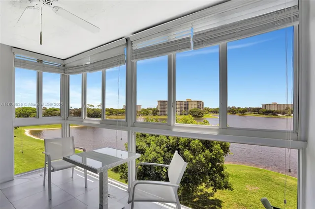 a view of a swimming pool and chairs in a patio