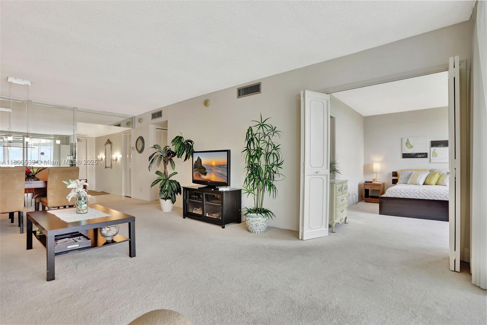 3091 North Course Drive, Unit 502 Pompano Beach, FL 33069 - Photo 13 of 42 a living room with furniture and a flat screen tv