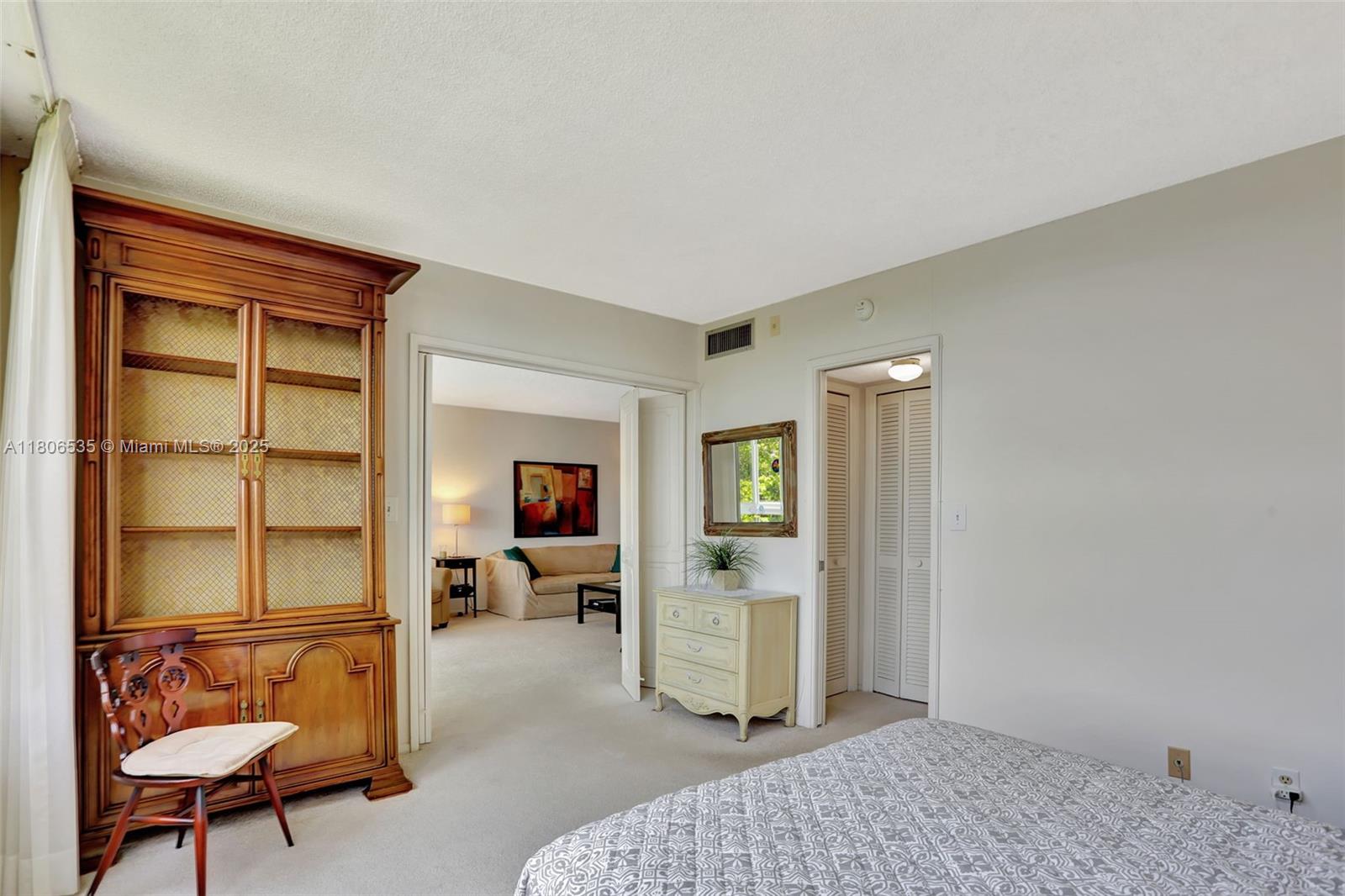 3091 North Course Drive, Unit 502 Pompano Beach, FL 33069 - Photo 16 of 42 a bedroom with furniture and a window