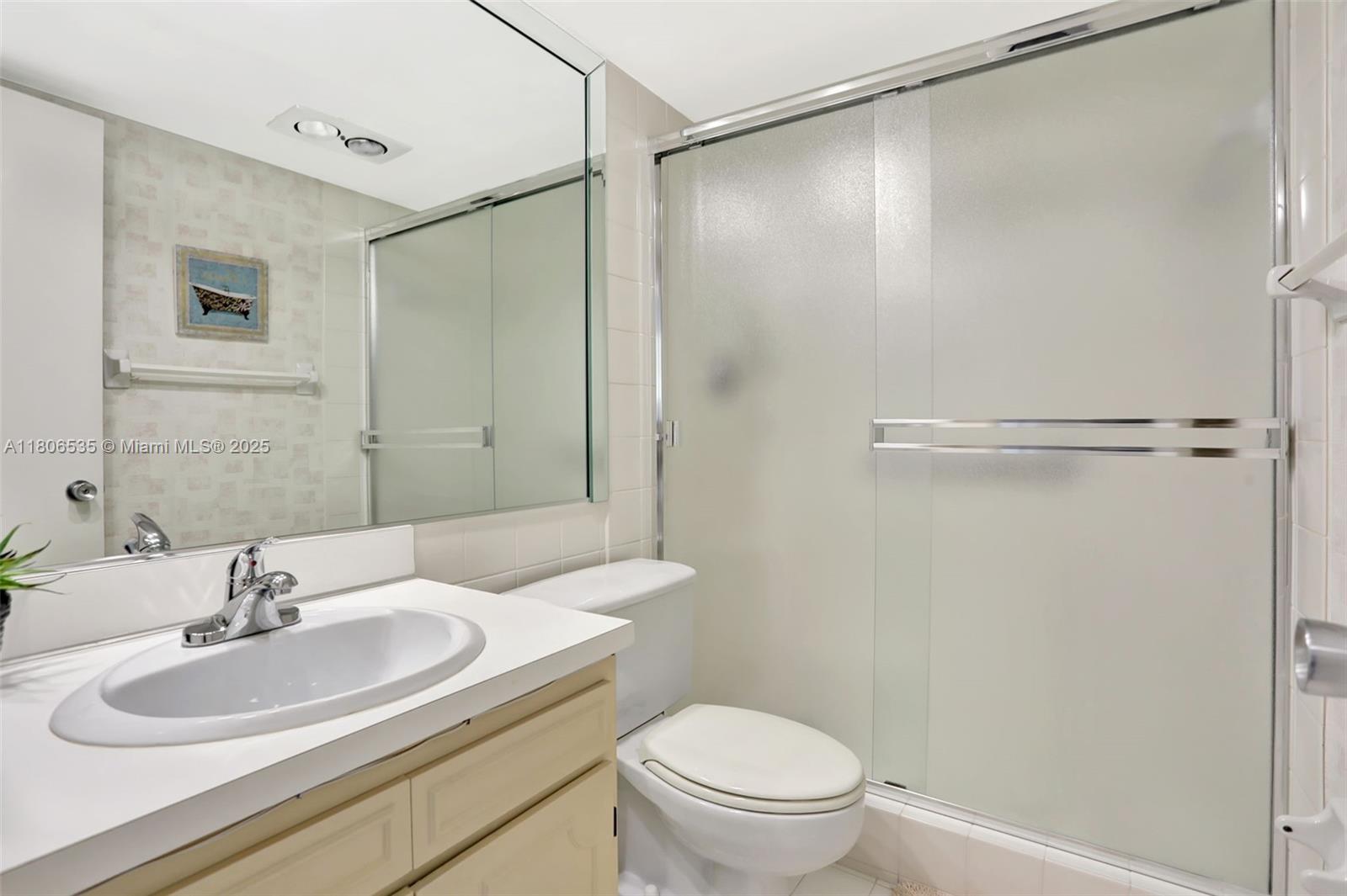 3091 North Course Drive, Unit 502 Pompano Beach, FL 33069 - Photo 17 of 42 a bathroom with a sink toilet and shower