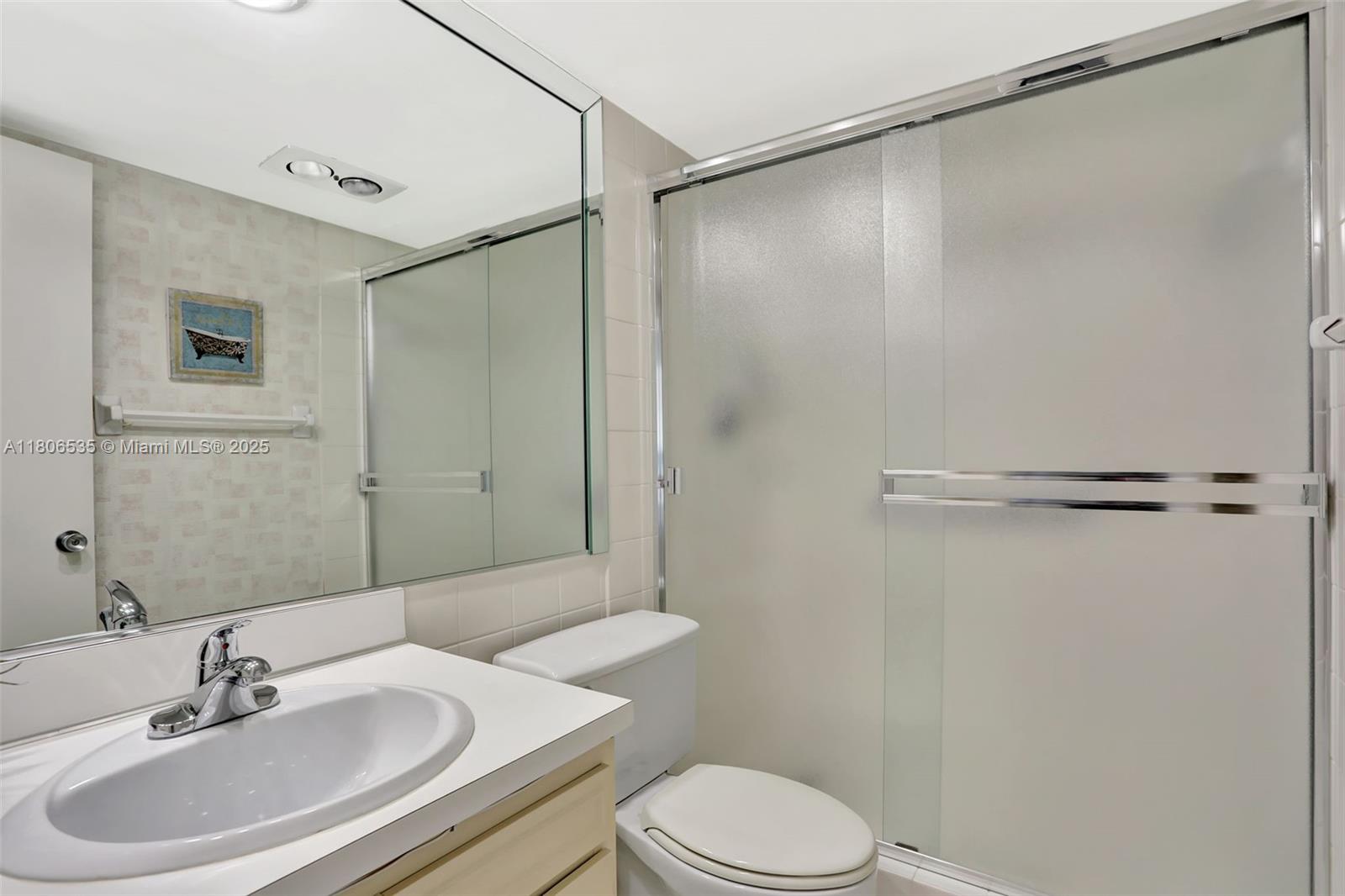 3091 North Course Drive, Unit 502 Pompano Beach, FL 33069 - Photo 19 of 42 a bathroom with a sink toilet and shower