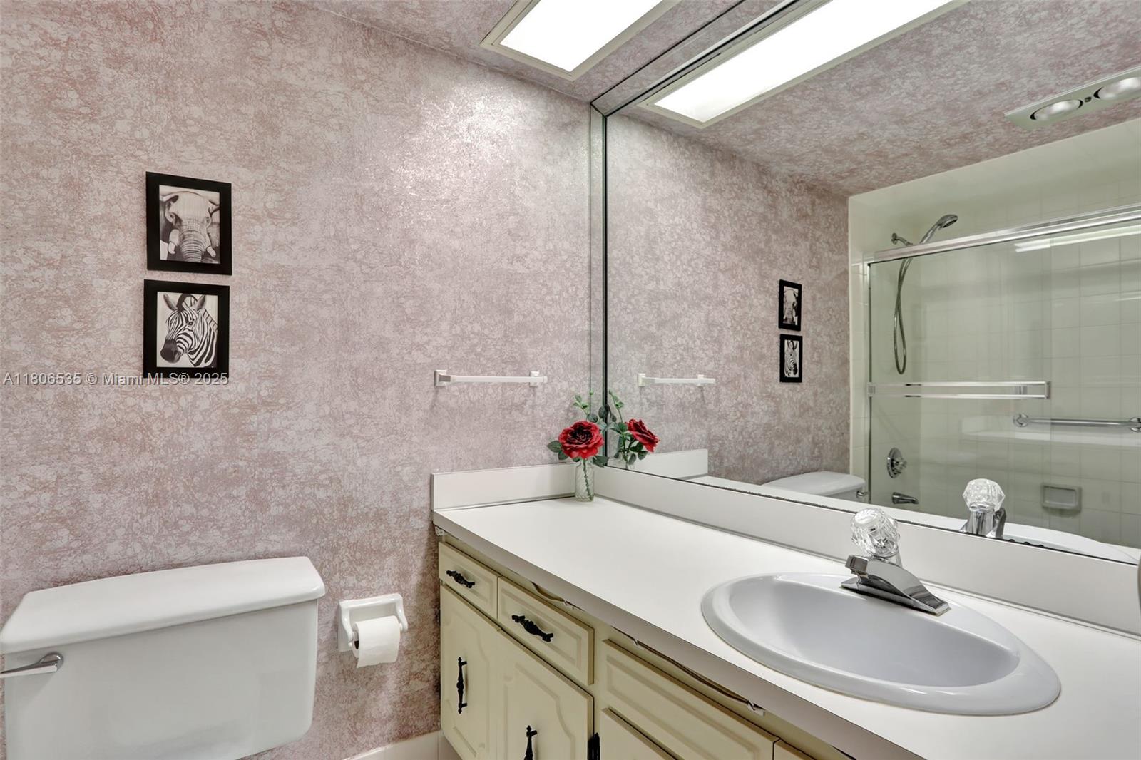 3091 North Course Drive, Unit 502 Pompano Beach, FL 33069 - Photo 24 of 42 a bathroom with a sink toilet and shower