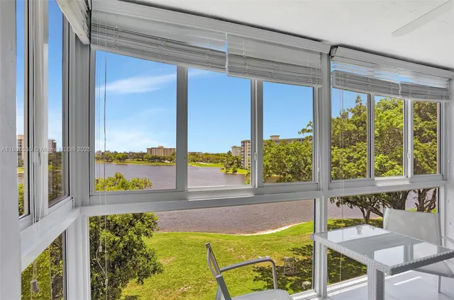 a view of a porch with a table and chairs