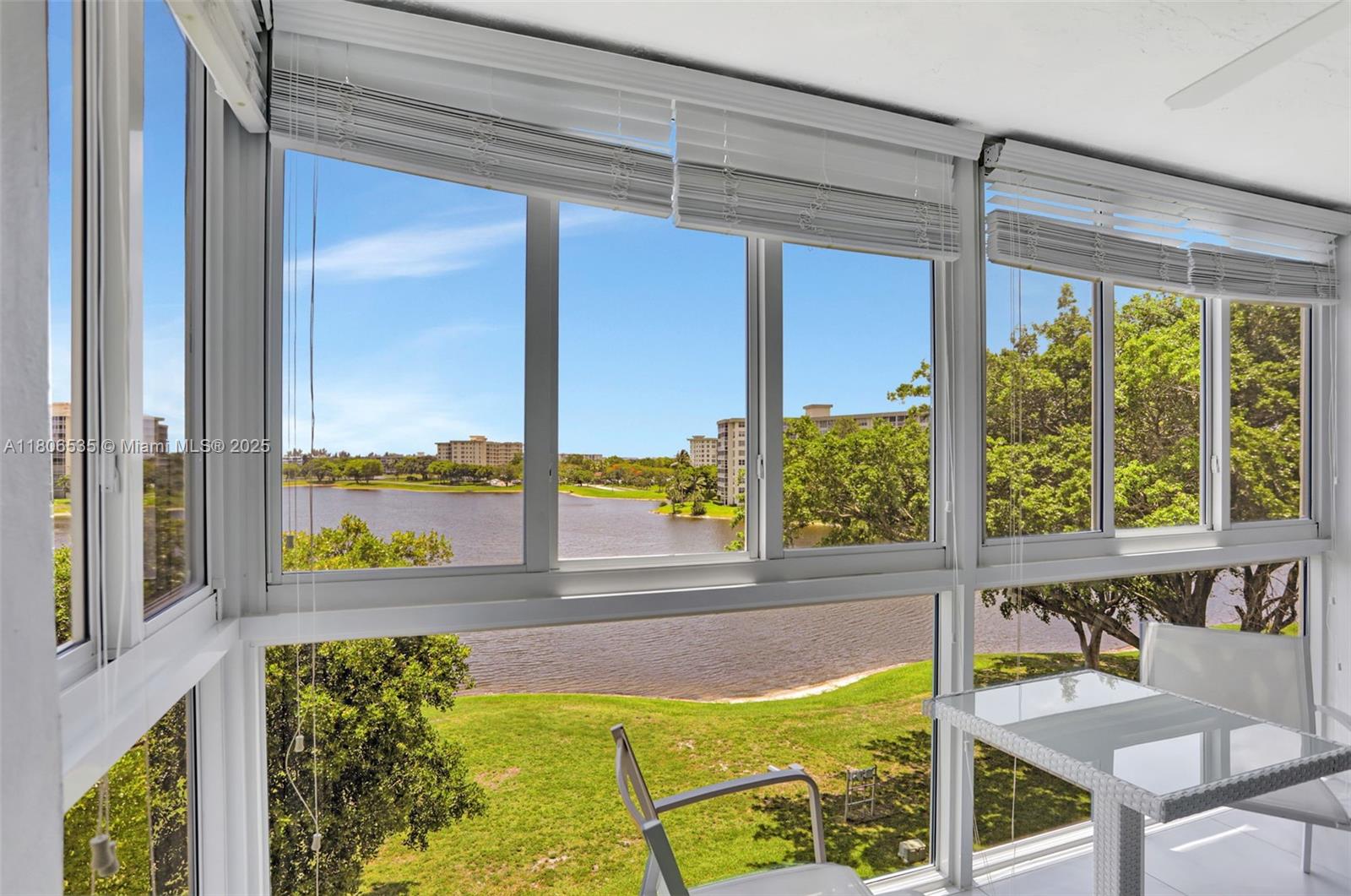3091 North Course Drive, Unit 502 Pompano Beach, FL 33069 - Photo 26 of 42 a view of a living room and floor to ceiling window
