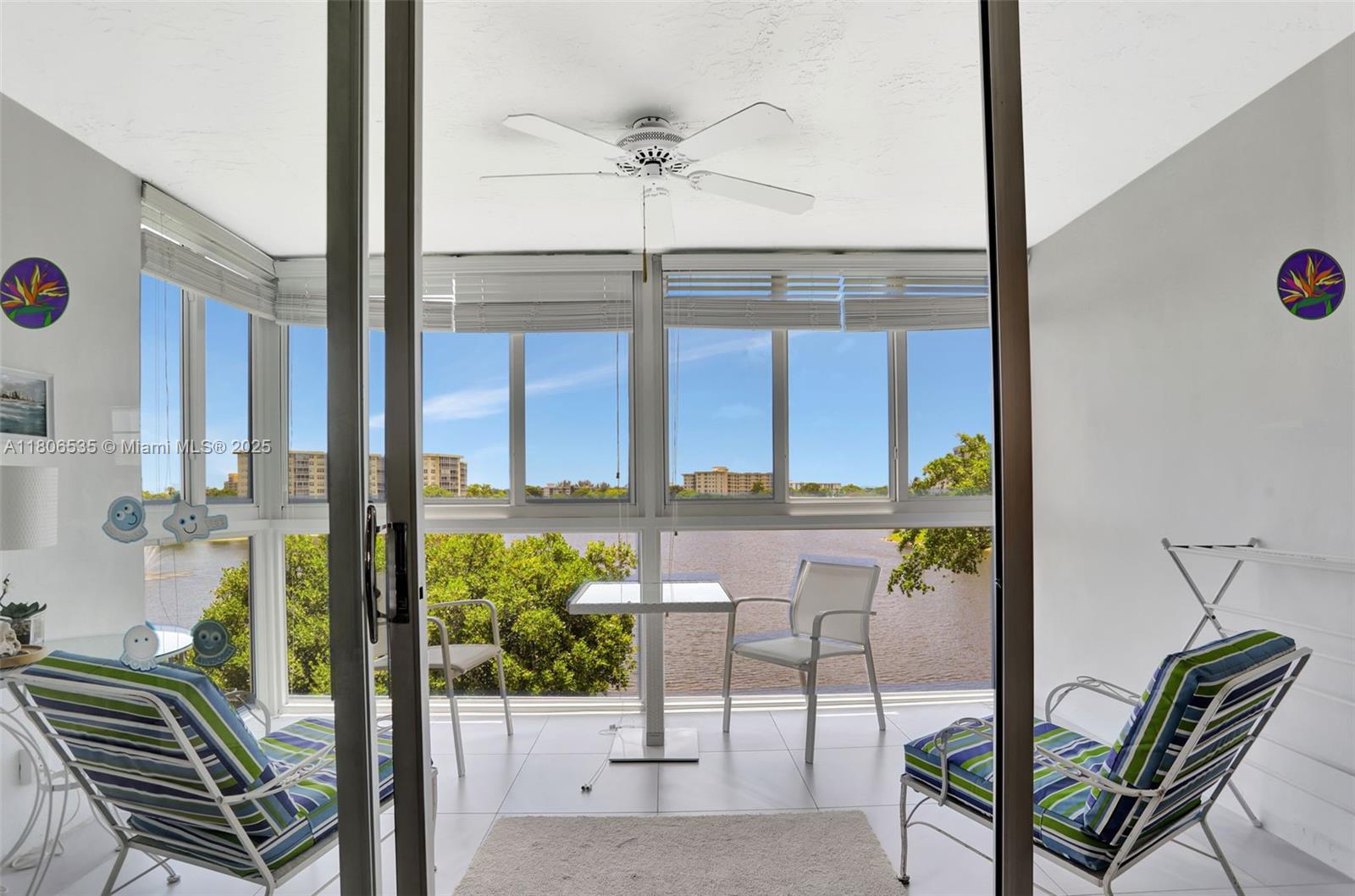 3091 North Course Drive, Unit 502 Pompano Beach, FL 33069 - Photo 27 of 42 a view of a porch with a table and chairs